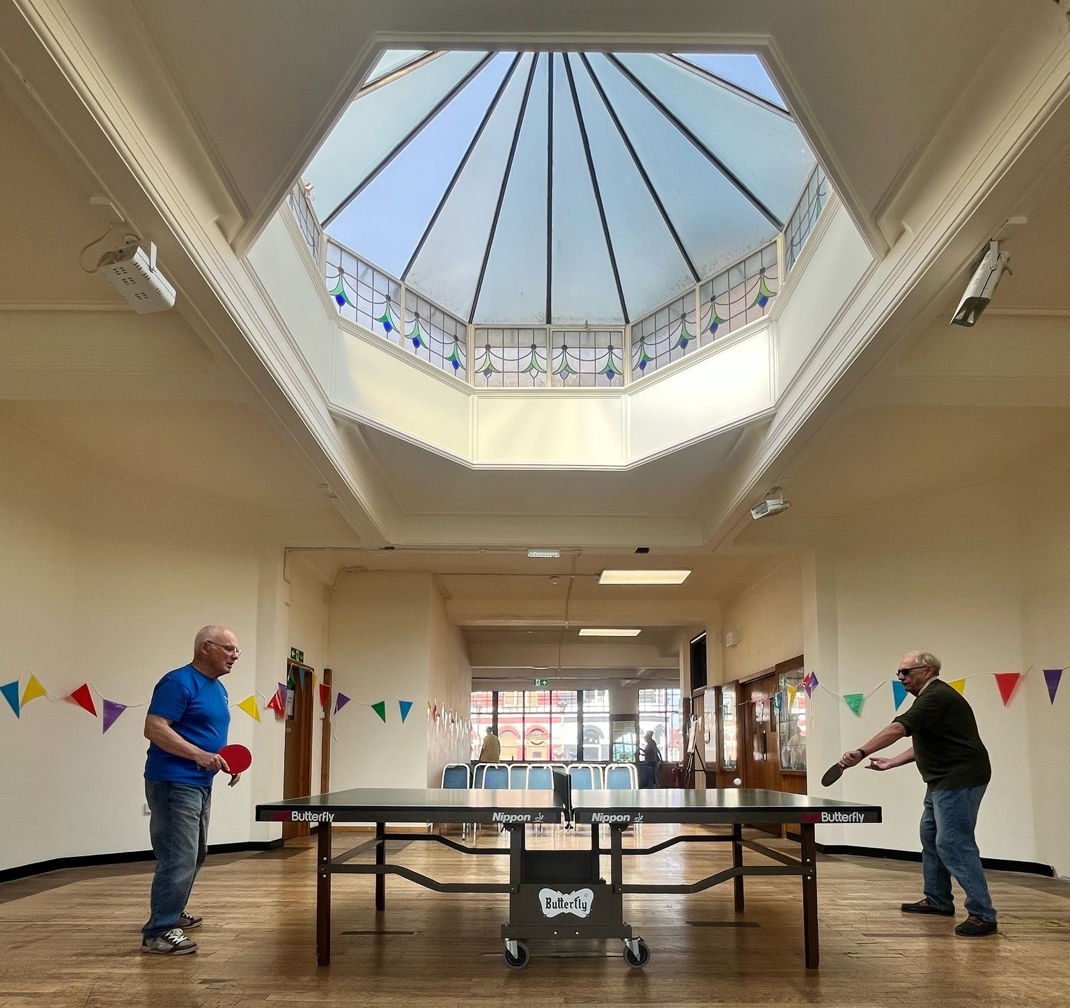 Two people playing table tennis under the skylight inside The Haven Community Hub. Credit: Age Concern Southend.
